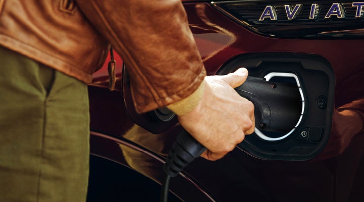 A hand is shown plugging in the charger into the charging port of a 2021 Lincoln Aviator | Mark Ficken Lincoln in Charlotte NC