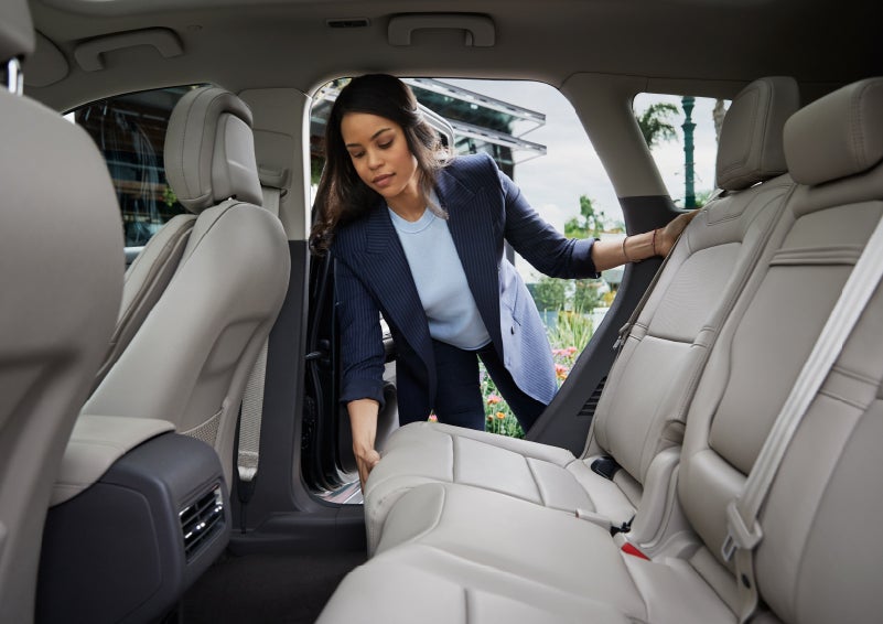 A woman slides the second-row seat forward to create more cargo space | Mark Ficken Lincoln in Charlotte NC