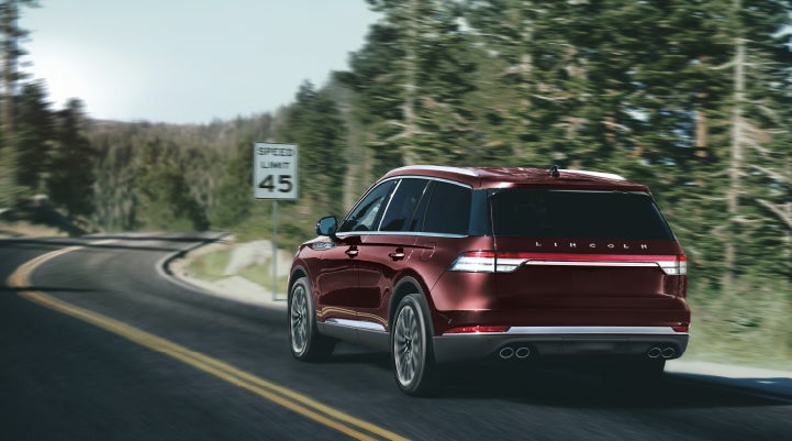 A 2024 Lincoln Aviator® SUV is being driven on a winding mountain road | Mark Ficken Lincoln in Charlotte NC