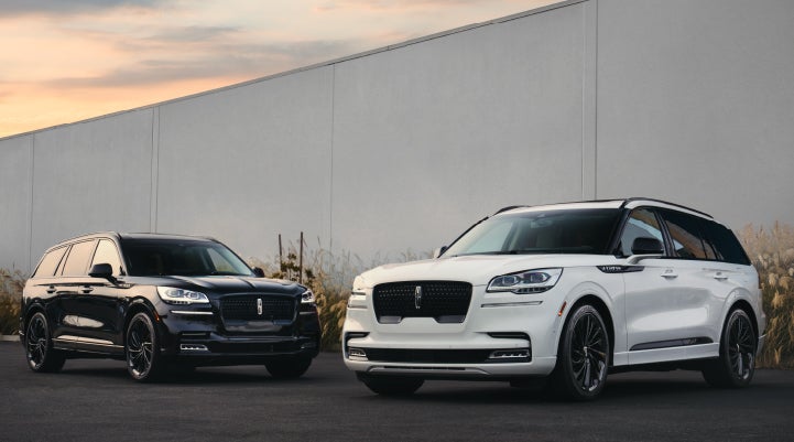 Two Lincoln Aviator® SUVs are shown with the available Jet Appearance Package | Mark Ficken Lincoln in Charlotte NC