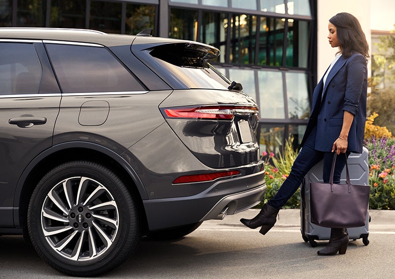 A woman with her hands full uses her foot to activate the available hands-free liftgate. | Mark Ficken Lincoln in Charlotte NC