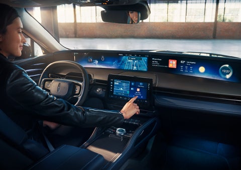 The driver of a 2024 Lincoln Nautilus® SUV interacts with the center touchscreen. | Mark Ficken Lincoln in Charlotte NC